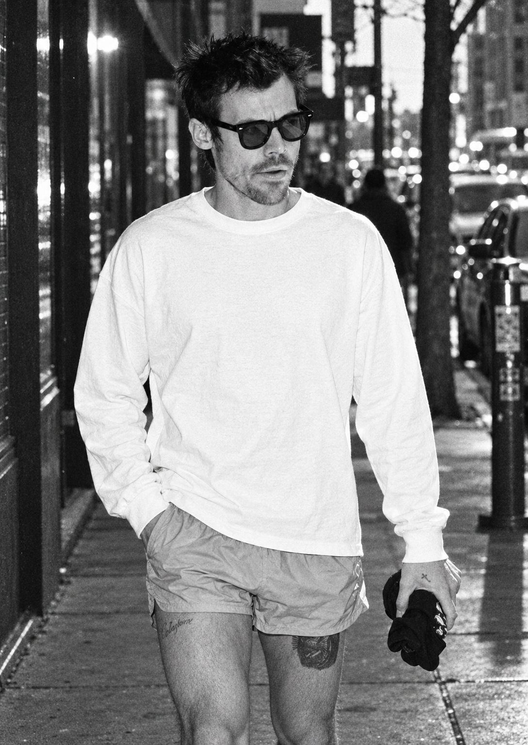 Model wearing a plain white unisex long sleeve shirt, ready to be printed with your own creation